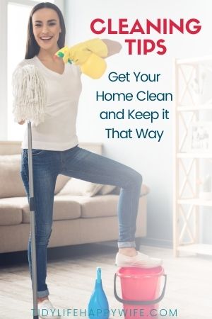 smiling woman with cleaning supplies