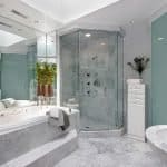 Clean tub, sink and toilet in a marble master bathroom