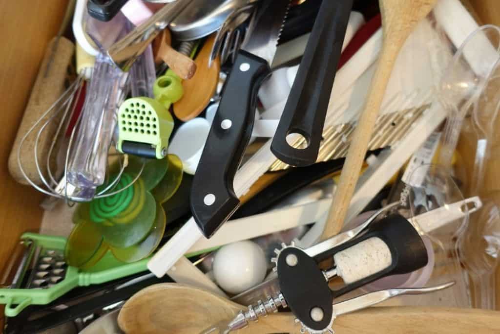 a cluttered kitchen utensil drawer is a decluttering task that could be completed quickly