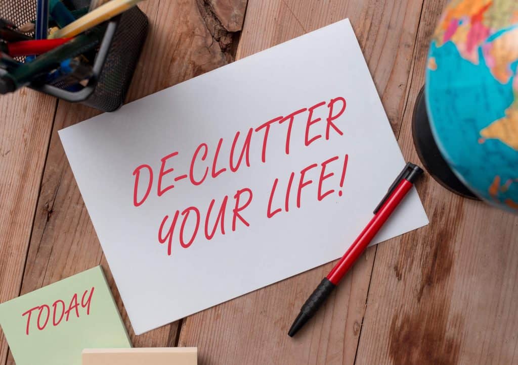 Declutter your life handwritten on a piece of notepad