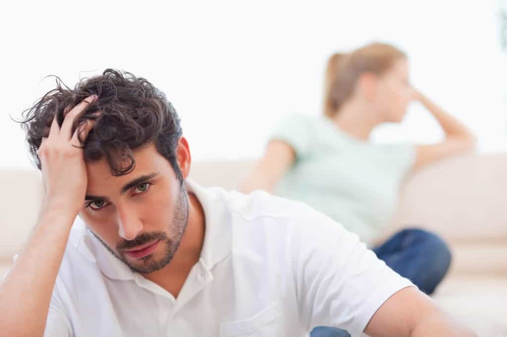 Distressed man and woman arguing over clutter