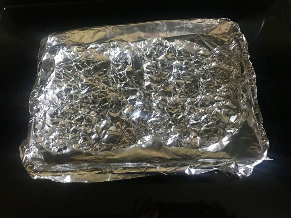 Foil lined jelly pan for cooking bacon in the oven