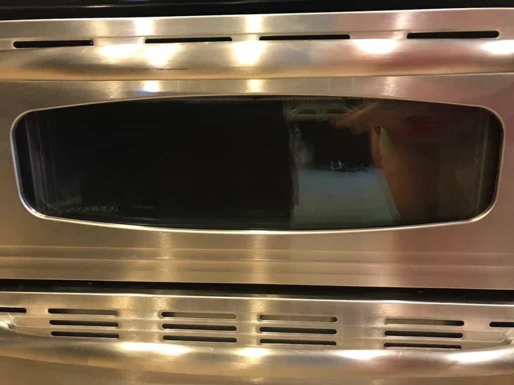 Shiny oven door after being deep cleaned.