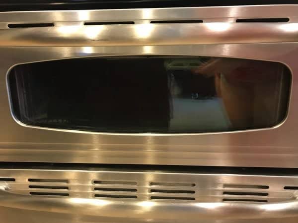 Shiny oven door after being deep cleaned.