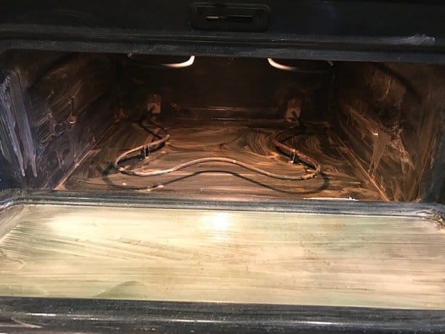 Interior of oven with cleaning mixture applied.