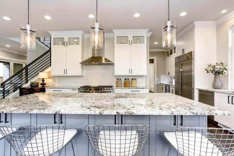 clean white kitchen with marble counters