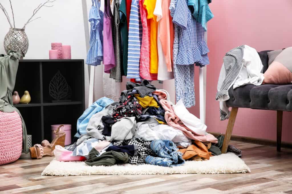 Messy bedroom with clothes in a pile