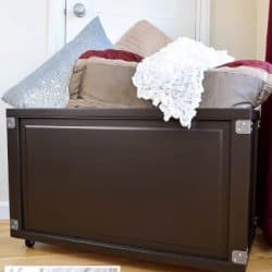 DIY rolling storage bin with bedroom blankets and pillows