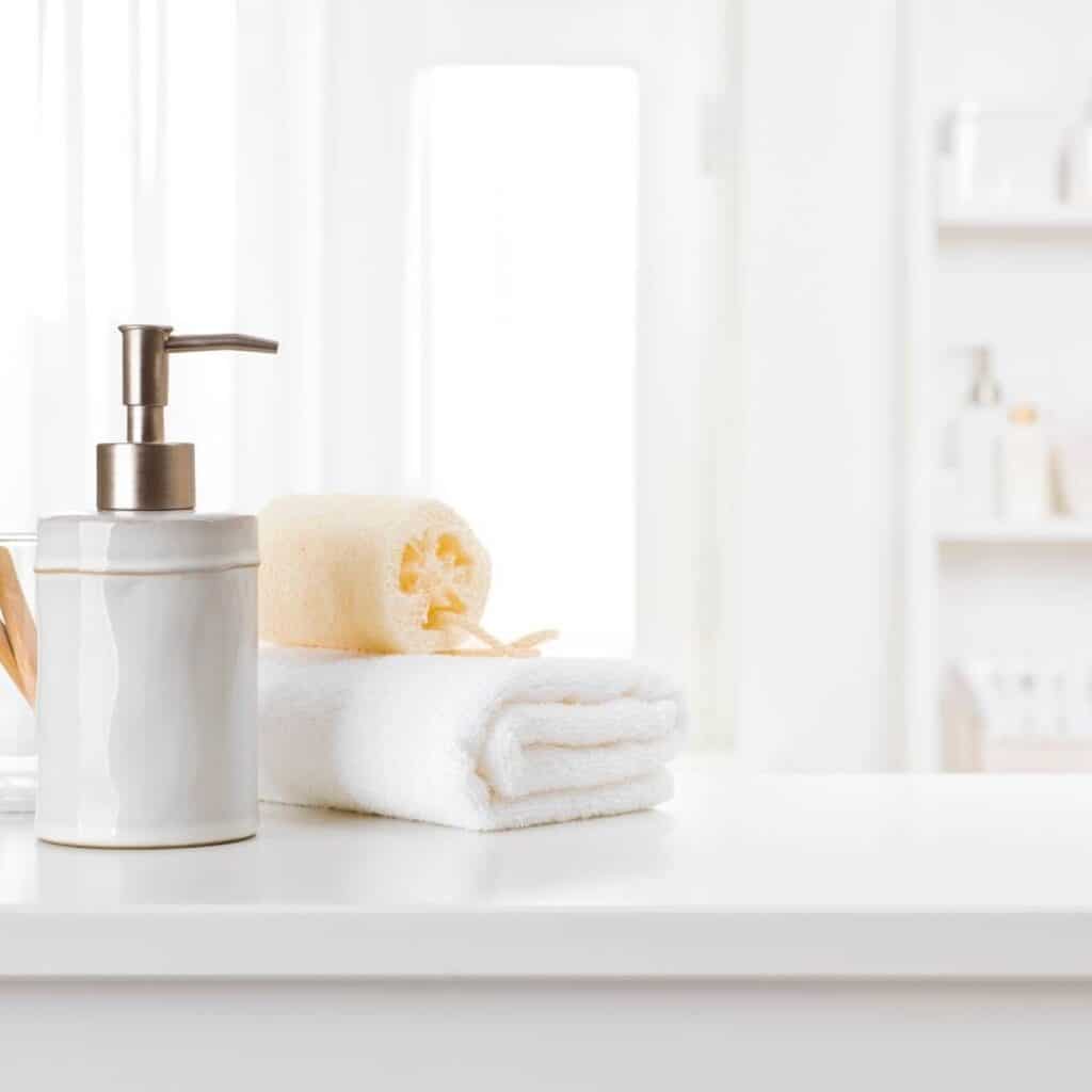 towels and soap dispenser sitting on bathroom counter