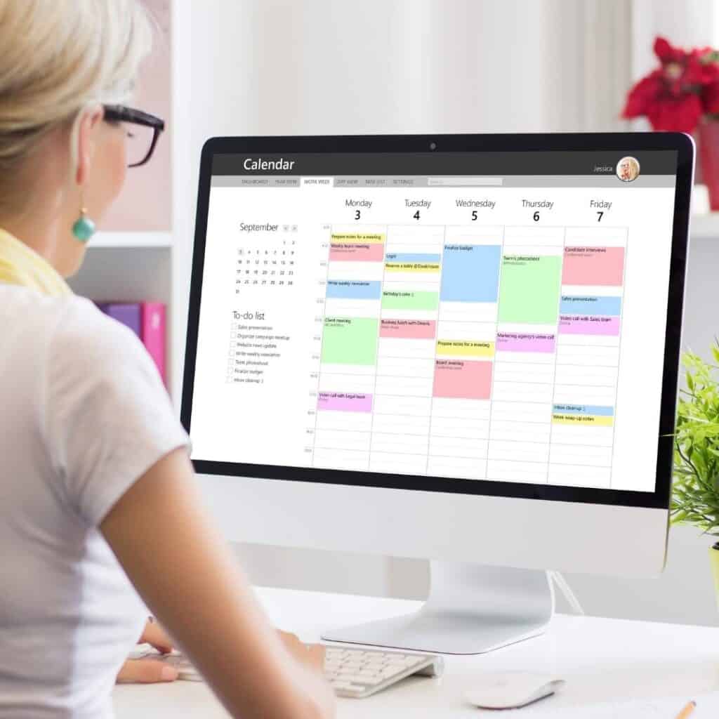 woman using calendar app on computer to organize her life