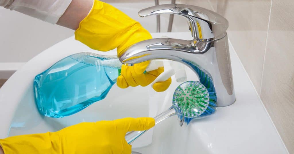 Using hydrogen peroxide and baking soda to clean lime scale buildup off a bathroom faucet.