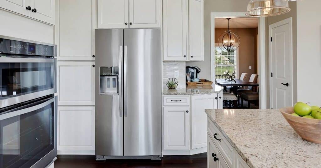 white kitchen with stainless steel french door refrigerator