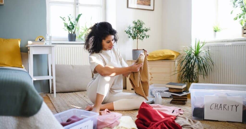 woman motivated to declutter clothing to give to charity