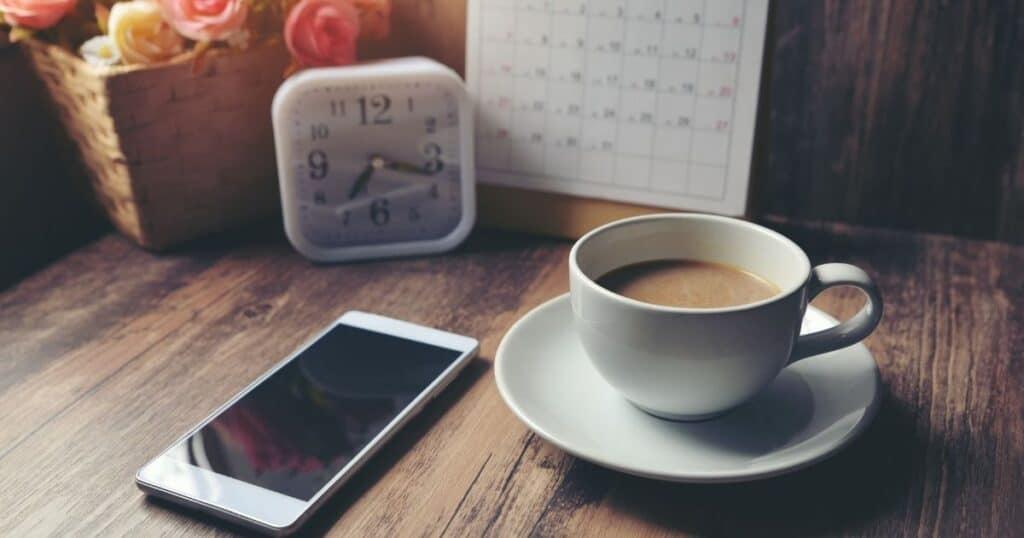 calendar, clock, iphone, and cup of coffee for organizing your life