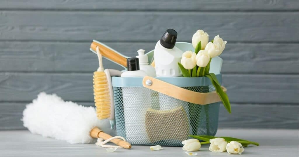 white tulips and spring cleaning supplies in a basket